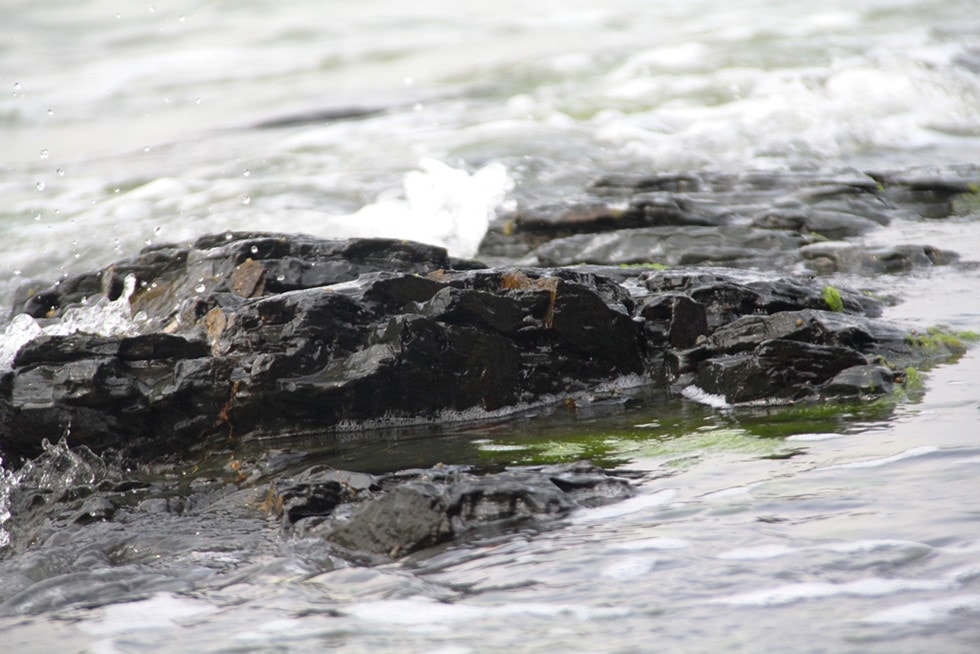 The stone blocks are in pure black, sparkling besides water here.