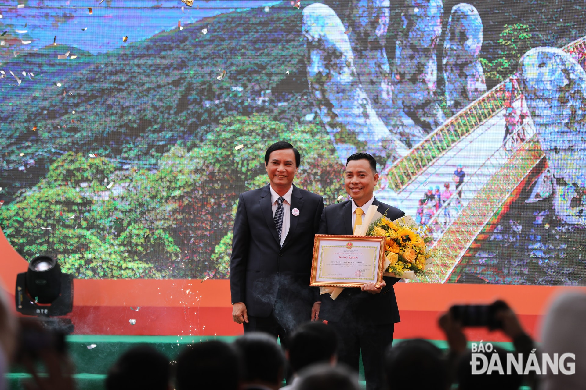 Phó chủ tịch UBND thành phố Trần Văn Miên (trái) tặng bằng khen của Chủ tịch UBND thành phố cho Công ty CP Dịch vụ cáp treo Bà Nà vì có thành tích xuất sắc cho sự phát triển của du lịch thành phố.