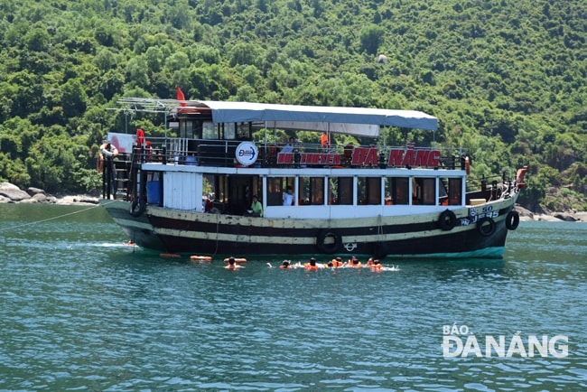 Khách du lịch tham quan Bãi Cát vàng khu vực bán đảo Sơn Trà bằng đường thủy. Ảnh: TRIỆU TÙNG