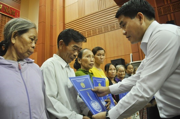 Chủ tịch UBND TP.Hà Nội Nguyễn Đức Chung tặng sổ tiết kiệm cho các hộ nghèo của tỉnh. Ảnh: N.Đ