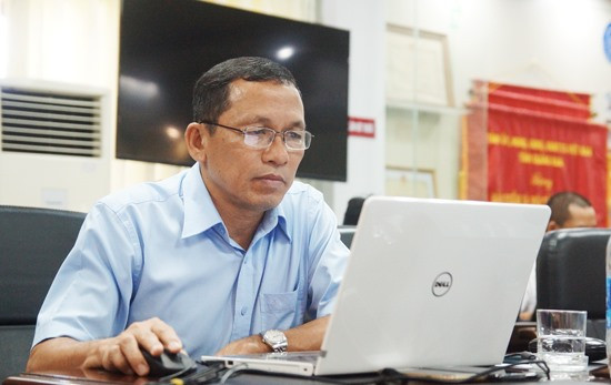 Ông Nguyễn Thanh Danh - Phó Giám đốc BHXH tỉnh rà soát nội dung câu trả lời trước khi đưa lên hệ thống xuất bản. Ảnh: PHAN VINH