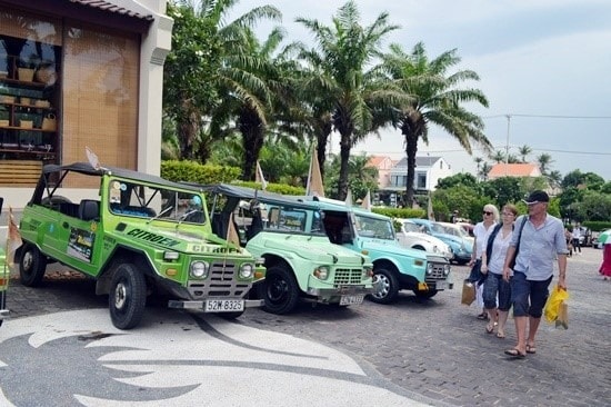 Visitors and ancient cars.