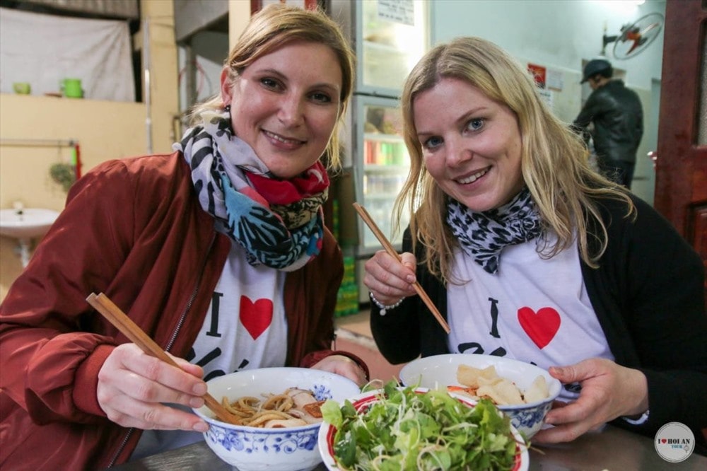 Tourists enjoy Cao lau noodles in Hoi An city, Quang Nam province.