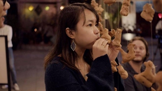 The pottery craft was one of the oldest trades that still remains in the UNESCO-recognised world heritage site Hoi An. A tourist tries to make to he, traditional toy for children in Vietnam at Thanh Ha pottery village. Photo: CAND