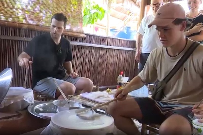 Visitors making rice paper.