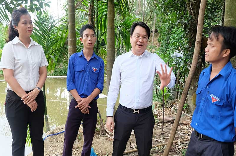 Ông Trần Quốc Bảo - Chủ tịch HĐQT Tập đoàn VN Đà Thành (thứ 3 từ bên trái) thăm mô hình kinh tế của anh Hồ Văn Vũ. Ảnh: M.L