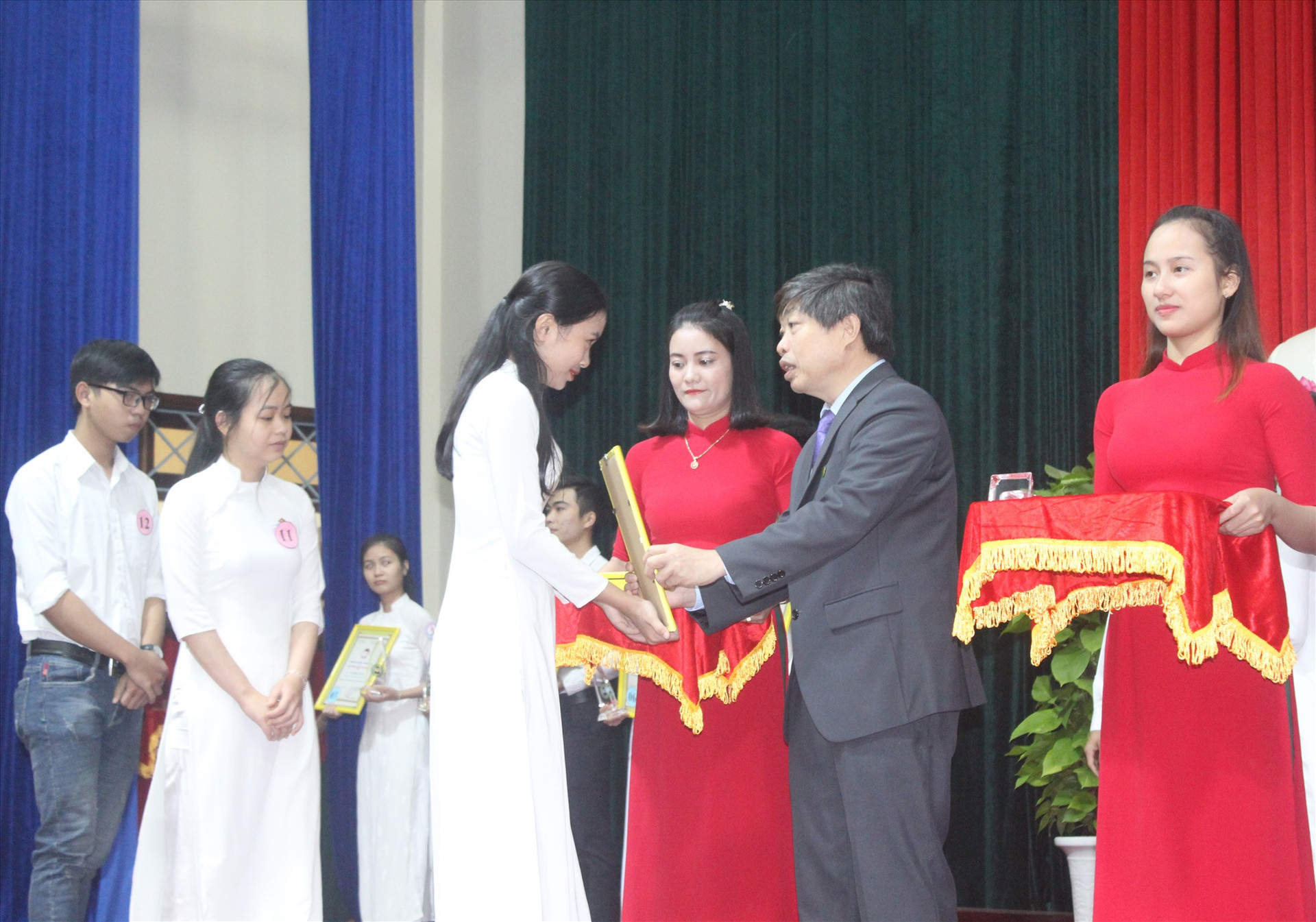 Chủ tịch UBND huyện Tiên Phước Hường Văn Minh trao thưởng cho các sinh viên xuất sắc. Ảnh: D.L