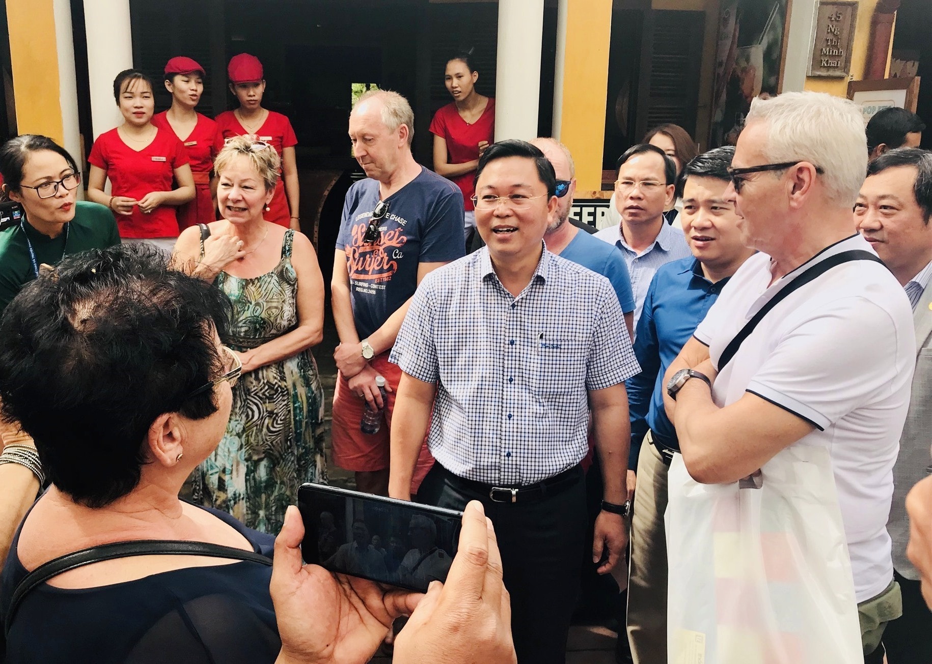 Chairman Thanh (strike T-shirt) talks to visitors in Hoi An city