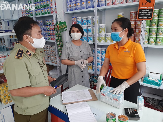 Lực lượng quản lý thị trường kiểm tra việc thực hiện các biện pháp trong việc phòng, chống Covid-19 tại một số cửa hàng tiện lợi trên địa bàn quận Hải Châu vào sáng 1-4. Ảnh: KHÁNH HÒA