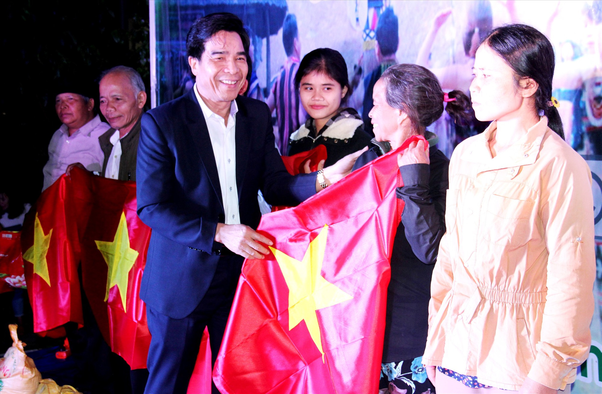 Đồng chí Lê Văn Dũng tặng lá cờ Tổ quốc cho đồng bào biên giới trong chương trình “Xuân biên phòng - ấm lòng dân bản” năm 2020. Ảnh: ALĂNG NGƯỚC