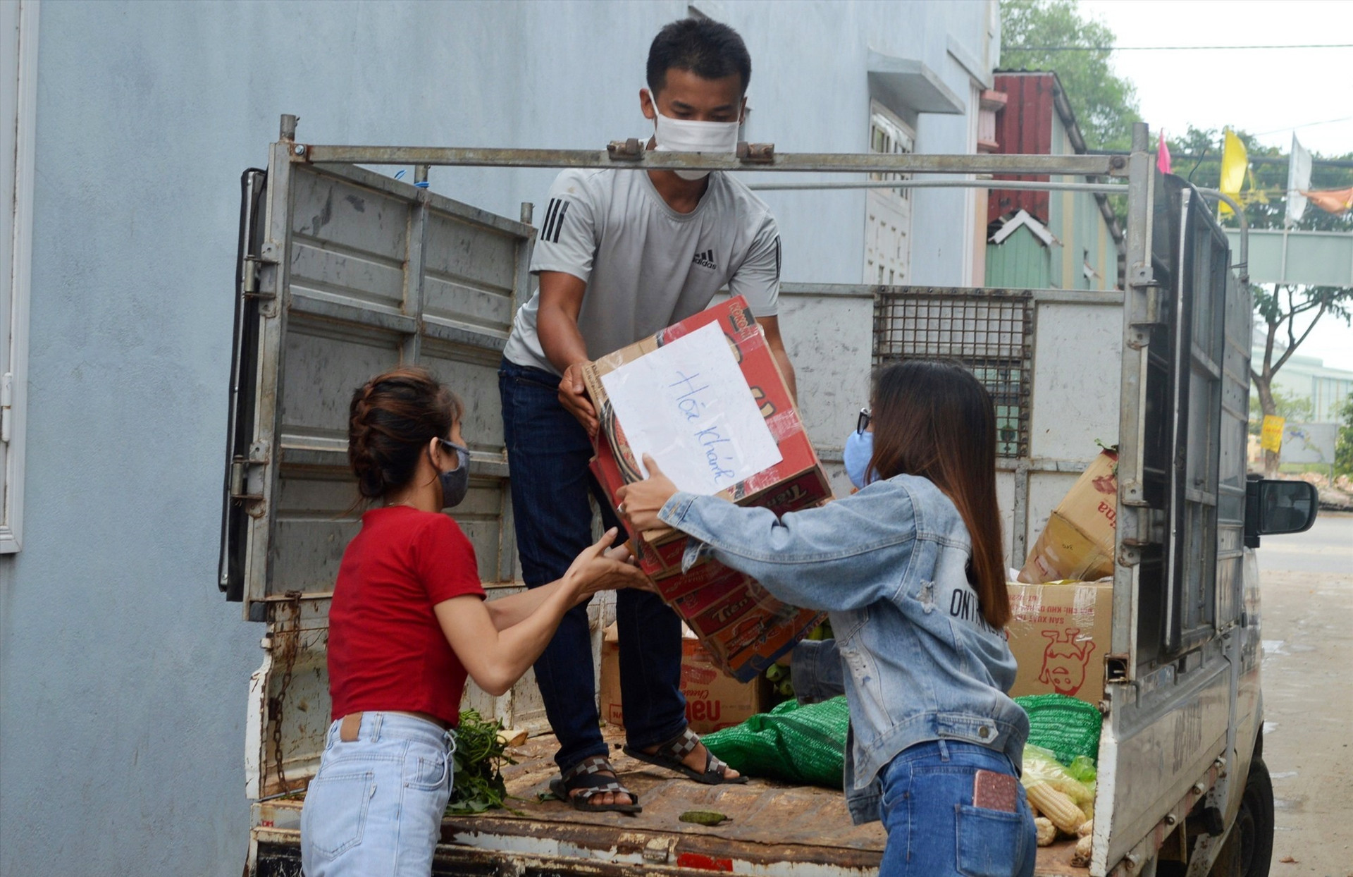Công nhân nhận hàng cứu trợ từ xe hàng nông sản của đồng bào Cơ Tu (ảnh V.L)