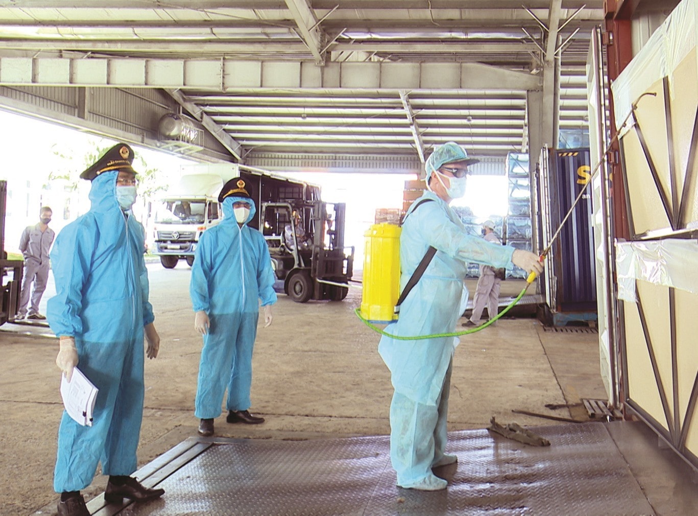 Spraying disinfectant on containers