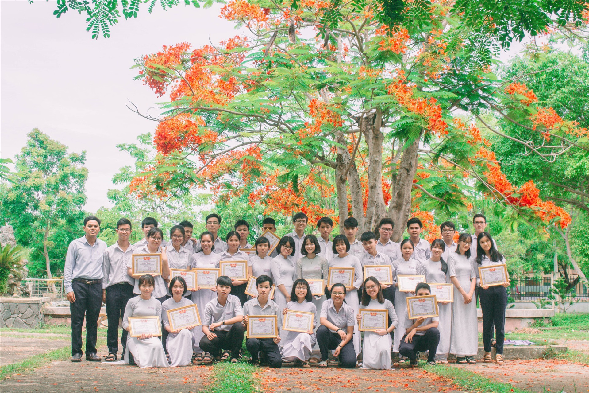 Phạm Thị Phương Thanh (bìa phải, hàng đứng) cùng thầy chủ nhiệm và các bạn. Ảnh: NVCC