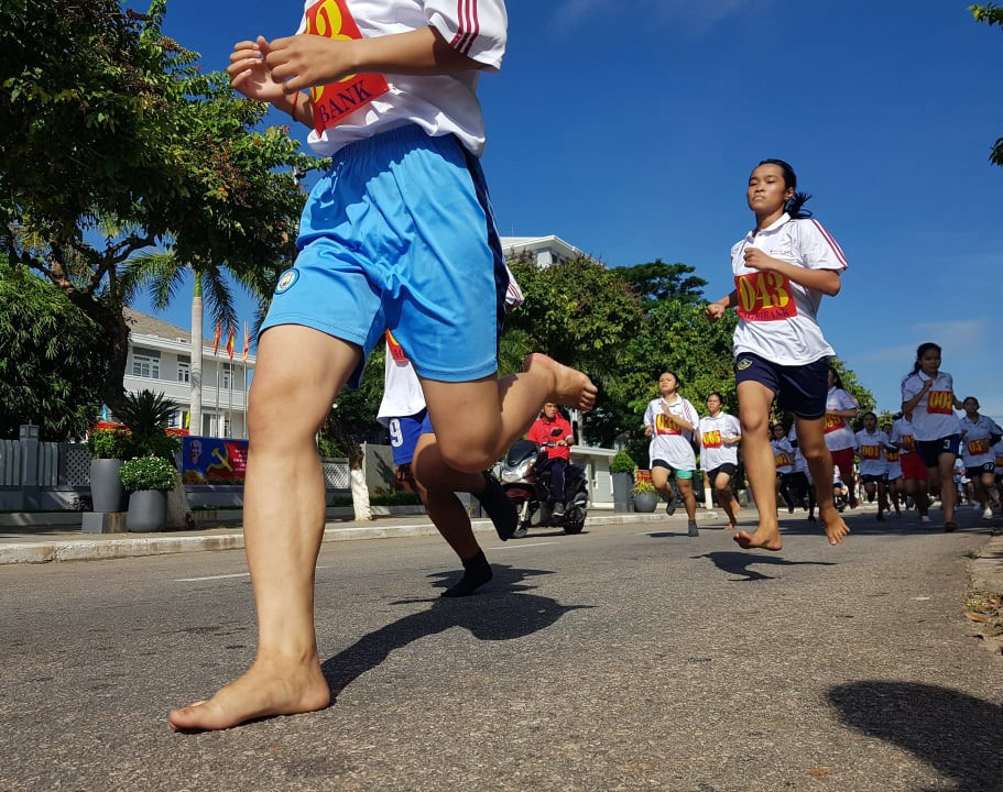 Những đôi chân trần của các nữ vận động viên miền núi trên đường chạy 1.500m nữ THPT.