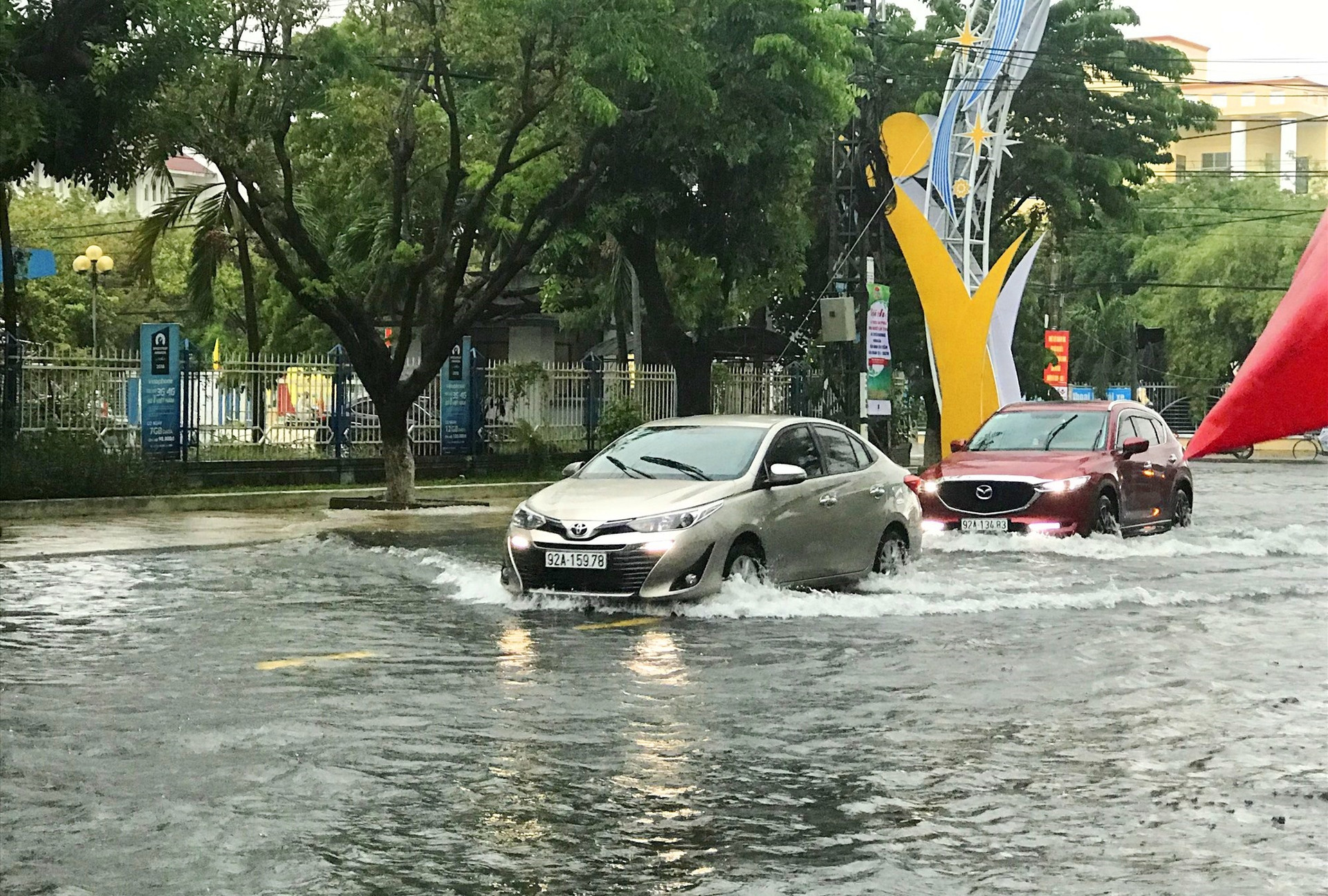 Xe ô tô lưu thông qua ngã tư Phan Bội Châu - Trần Hưng Đạo khó khăn do mưa lớn. Ảnh: V.A