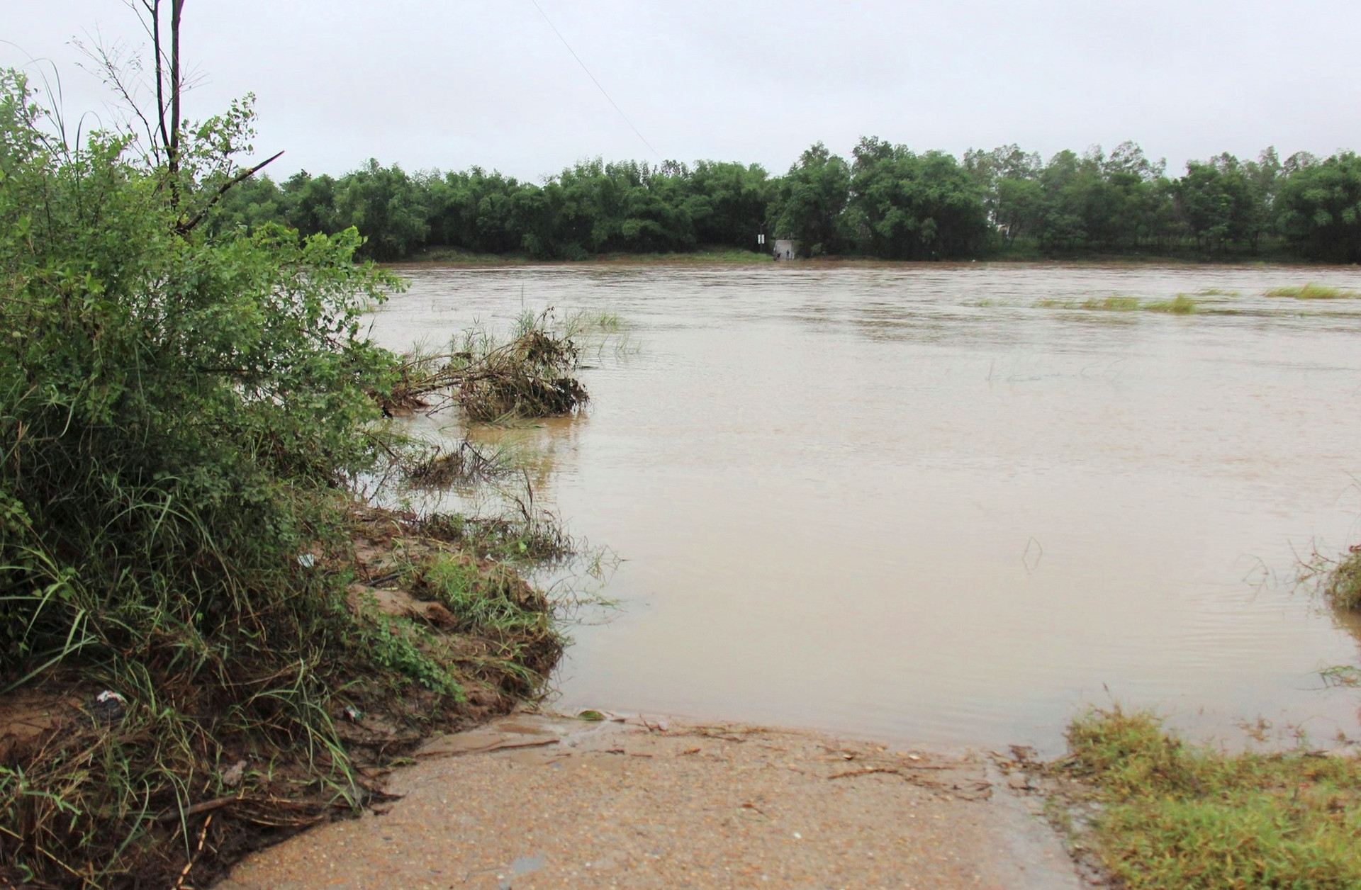 Con đường từ thôn Lệ Bắc, xã Duy Châu, huyện Duy xuyên nối ra trung tâm xã bị nước lũ nhấn chìm trong sáng 17.10. Ảnh: H.A
