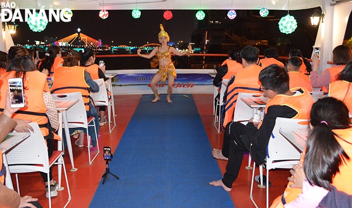Ngoài thưởng ngoạn sông Hàn về đêm, du khách còn được thưởng thức các tiết mục múa Chăm, xem cầu Rồng phun lửa, phun nước. Ảnh: THU HÀ.