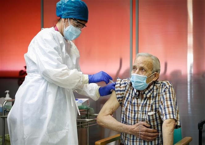 Nhân viên y tế tiêm vaccine phòng Covid-19 cho người dân tại Madrid, Tây Ban Nha, ngày 27-12-2020. Ảnh: AFP/TTXVN