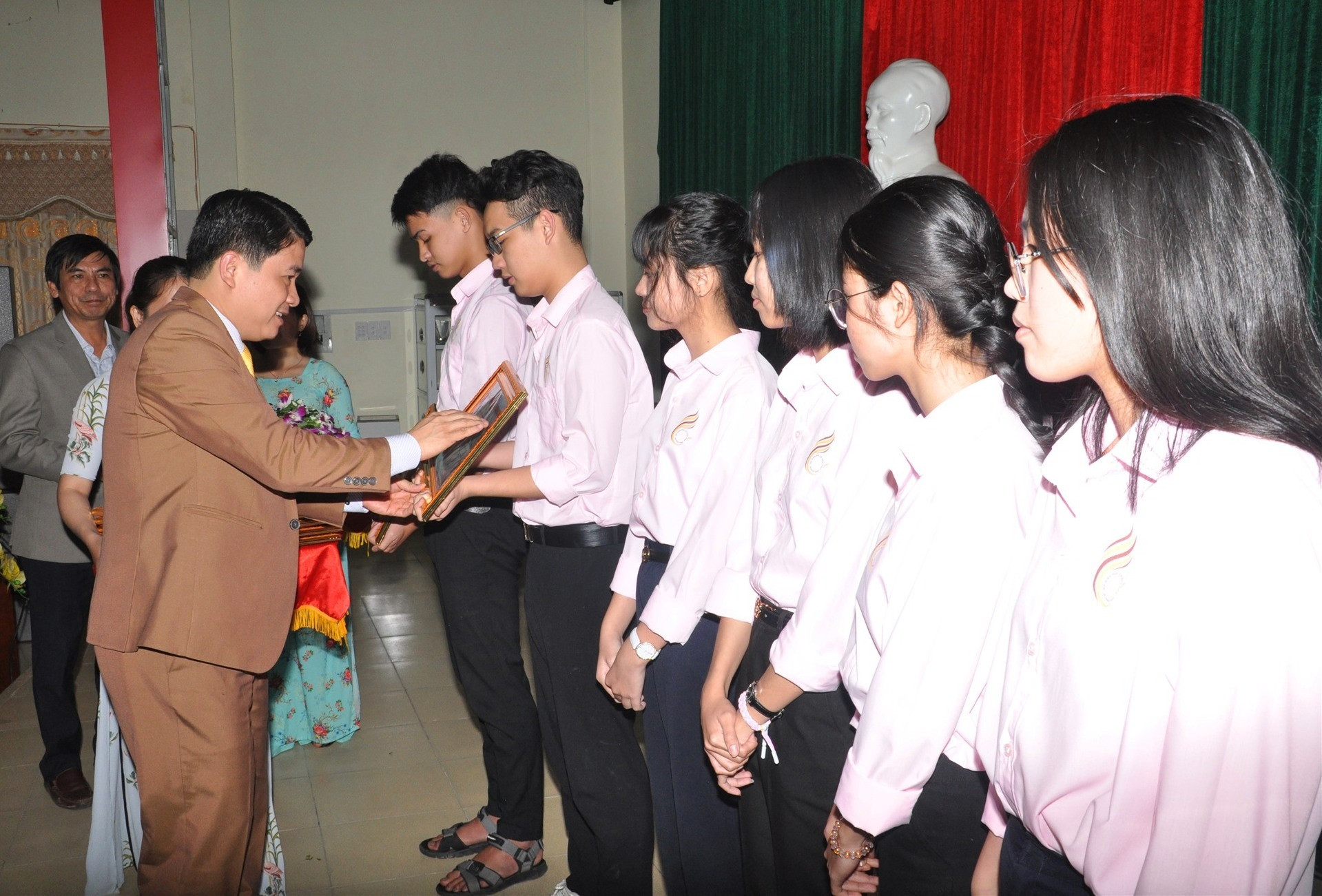 Phó Chủ tịch UBND tỉnh Trần Văn Tân tặng bằng khen cho cac em học sinh đoạt giải nhì. Ảnh: X.P