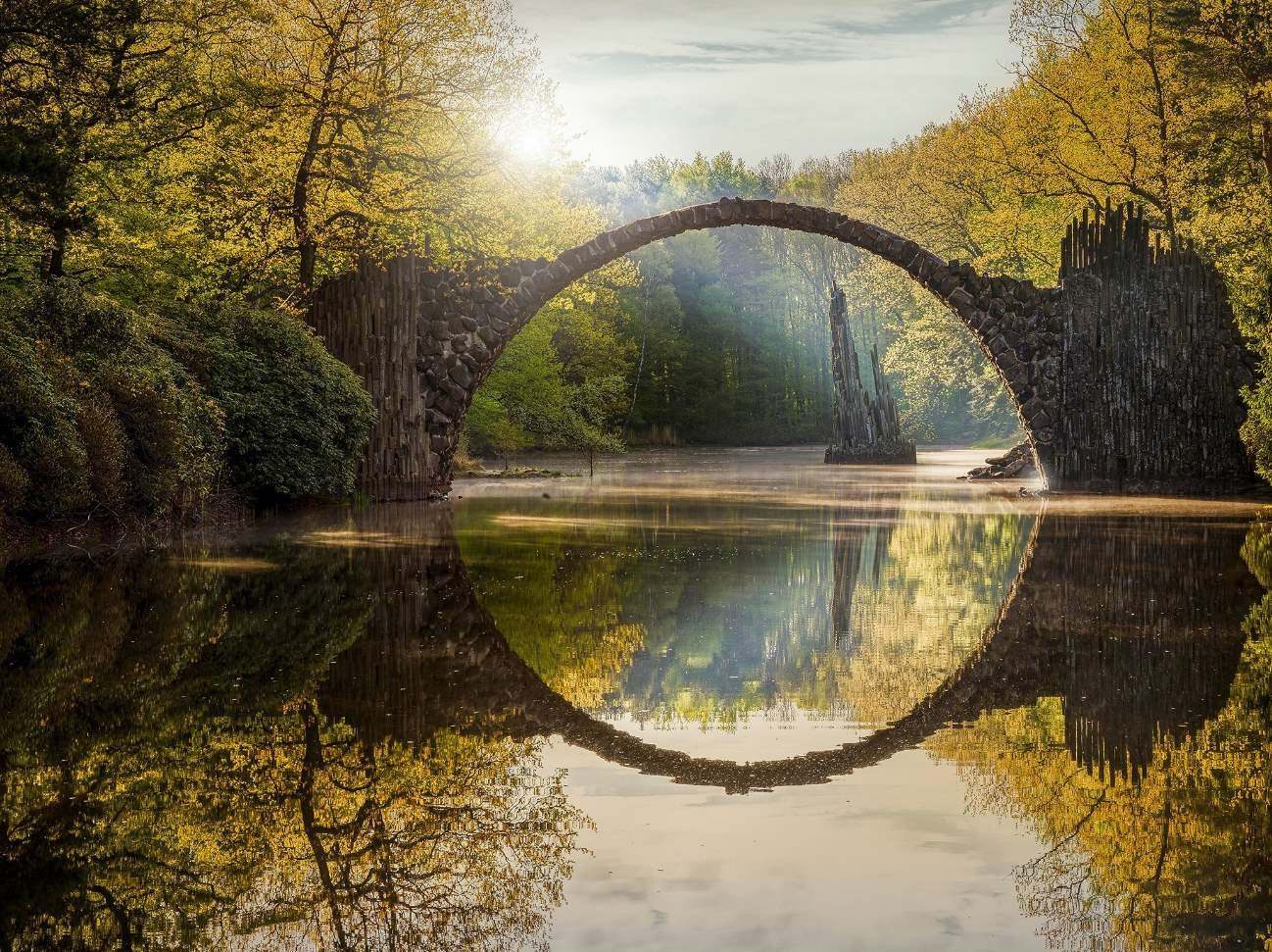 The bridge is in Dahu park, Taipei, Taiwan. It is very charming, especially at moon nights.