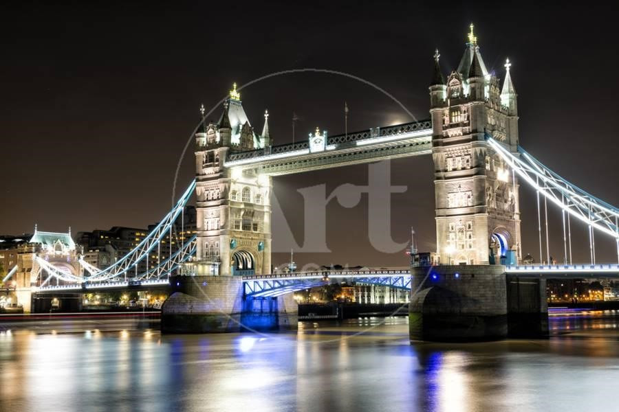 Tower Bridge across the Thames (London, England) is considered as the symbol of London and a precious architectural pearl. There is a double of towers in the middle of the bridge that can be lifted to unstop large ships going along the river.