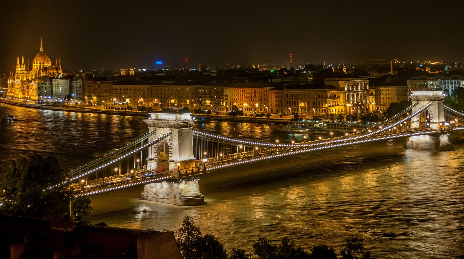 Chain Bridge is in Budapest, Hungary. The bridge makes the city more charming and attractive to visitors, especially at night.