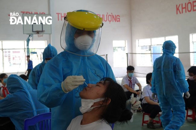 UBND thành phố lên kế hoạch xét nghiệm hơn 16.200 người liên quan đến kỳ thi tốt nghiệp THPT. Trong ảnh: Nhân viên y tế lấy mẫu xét nghiệm cho học sinh chuẩn bị thi vào khối THPT ngày 13-6. Ảnh: PHAN CHUNG