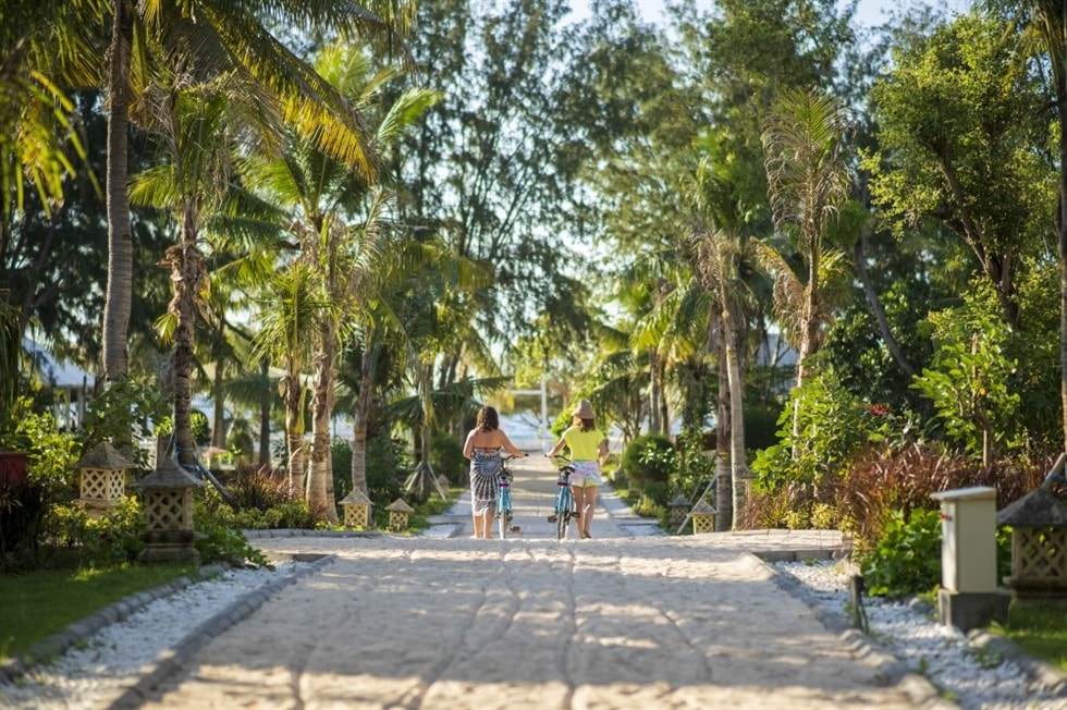 Tourists walk their bicycles at Gili Eco Villas, located on Gili Trawangan, Indonesia. Courtesy of Booking.com