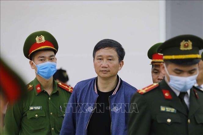 Cảnh sát dẫn giải bị cáo Trịnh Xuân Thanh (sinh năm 1966, nguyên: Chủ tịch Hội đồng quản trị, Tổng Giám đốc Tổng Công ty Cổ phần Xây lắp Dầu khí Việt Nam - PVC), chiều 15-3-2021. Ảnh: Doãn Tấn/TTXVN