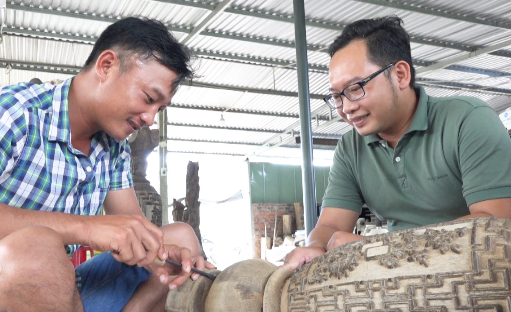 Ông Nguyễn Văn Trường (bên phải) cùng thợ đang chế tác sản phẩm trầm hương (ảnh chụp thời điểm dịch Covid-19 chưa bùng phát). Ảnh: H.Q