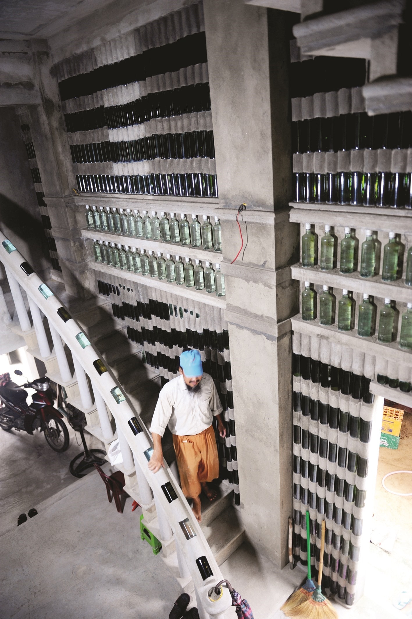 Mr. Linh’s house stairs are decorated with blue glass bottles.