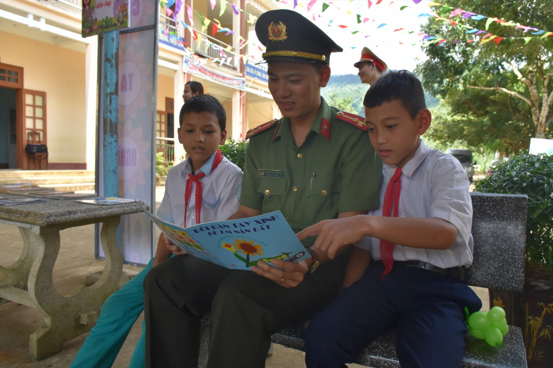 Phạm Hồng Trung đọc sách cùng các em nhỏ miền núi. Ảnh: M.L