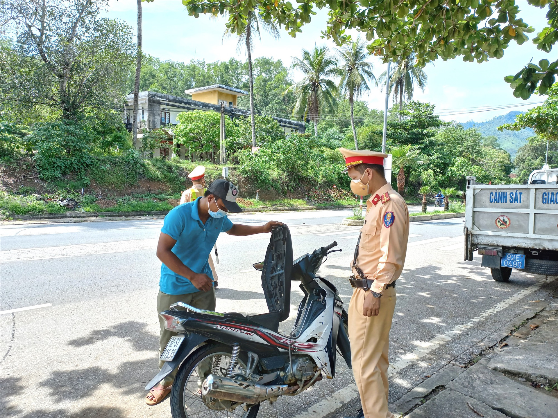 Cảnh sát giao thông Nam Giang kiểm tra, xử lý người đi xe máy không đội mũ bảo hiểm trên đường Hồ Chí Minh. Ảnh: C.T