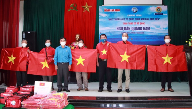 Trưởng Văn phòng Báo Người Lao Động và Chủ tịch LĐLĐ tỉnh Quảng Nam trao tặng cờ Tổ quốc cho các Nghiệp đoàn Nghề cá huyện Núi Thành. Ảnh: Báo Người Lao Động