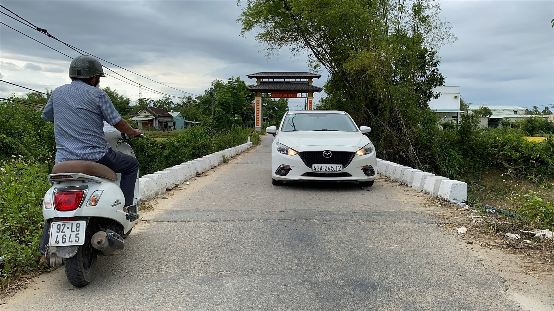 Khi có xe ô tô đi ngay qua cầu Tây Yên (xã Tam Đàn, Phú Ninh) người dân thường dừng lại cho xe chạy qua trước. Ảnh: H.V