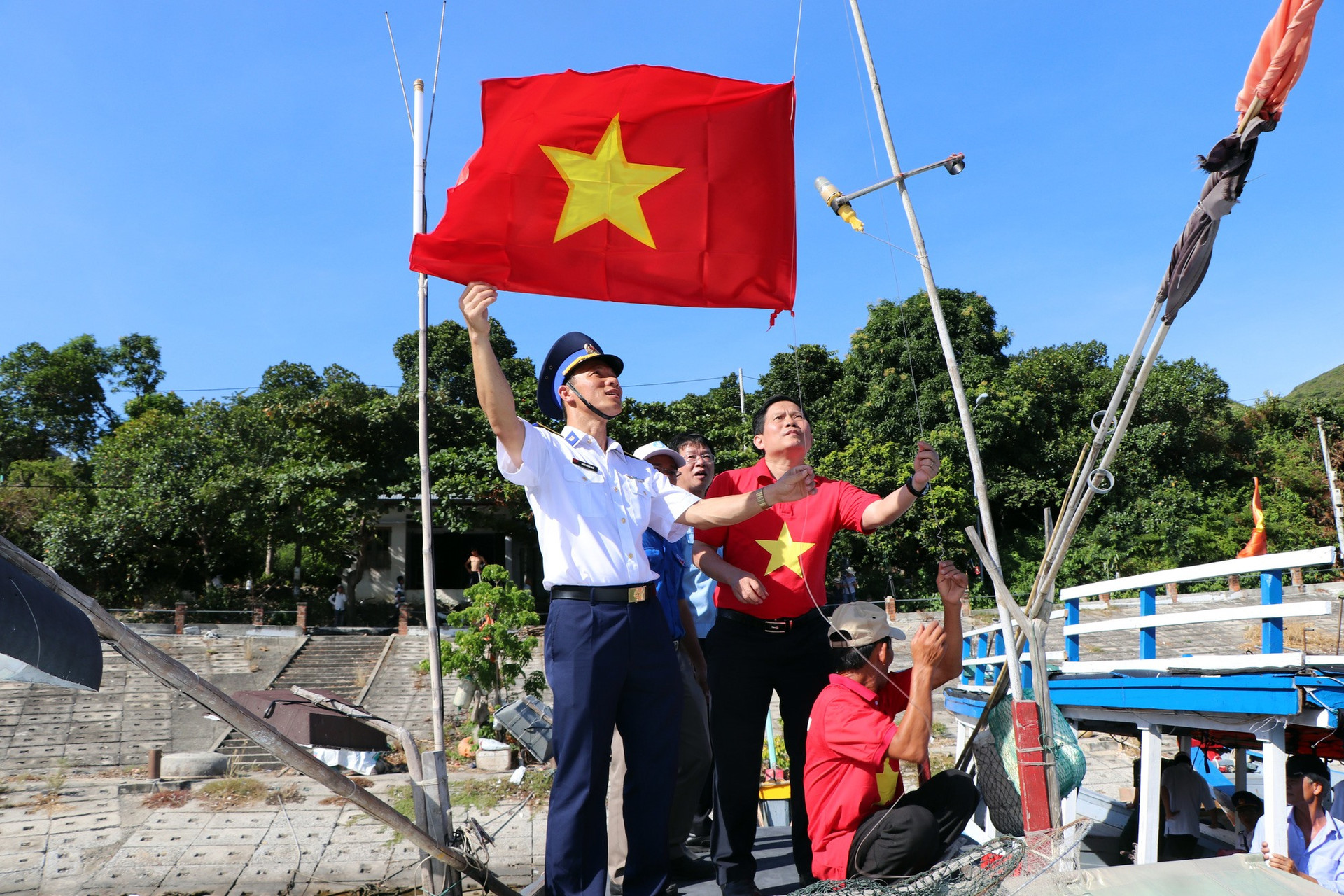Ông Tô Đình Tuân, Tổng Biên tập Báo Người Lao Động cùng lãnh đạo Bộ Tư lệnh Vùng Cảnh sát biển 2 trực tiếp leo lên trên các con tàu cùng ngư dân xã đảo Tân Hiệp thay cờ Tổ quốc vào tháng 7-2020.