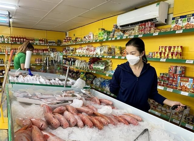 Người tiêu dùng tại siêu thị ở Việt Nam. Ảnh: VNA