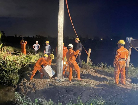 Công nhân ngành điện lao động xuyên đêm khắc phục thiệt hại do bão số 4 gây ra. Ảnh: PC