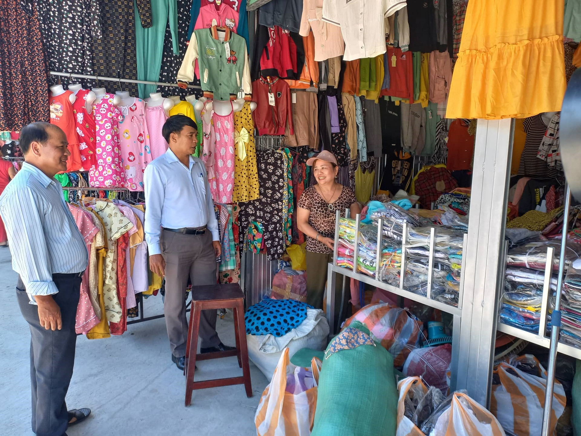 Lãnh đạo huyện Quế Sơn và xã Quế Xuân 1 hỏi thăm các hộ tiểu thương vào buôn bán tại chợ Bà Rén mới. ảnh DT
