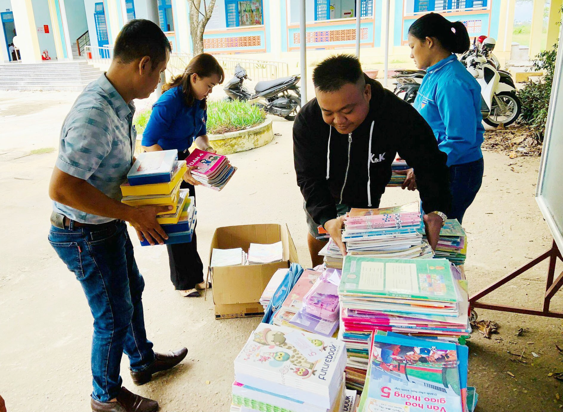 Các thầy cô giáo và đoàn viên thanh niên xếp sách vở ủng hộ từ chương trình để gửi tặng cho học sinh vùng bão lũ. Ảnh: G.B