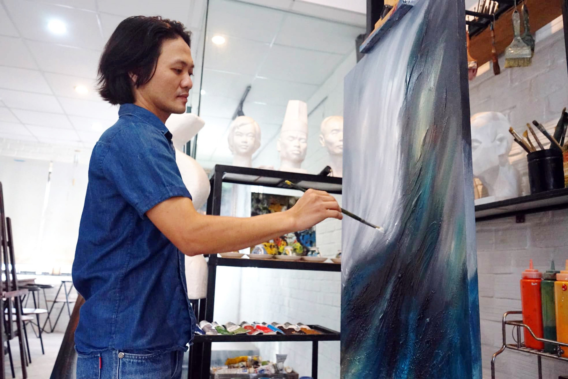Họa sĩ Huỳnh Công Thành tại xưởng vẽ của mình.