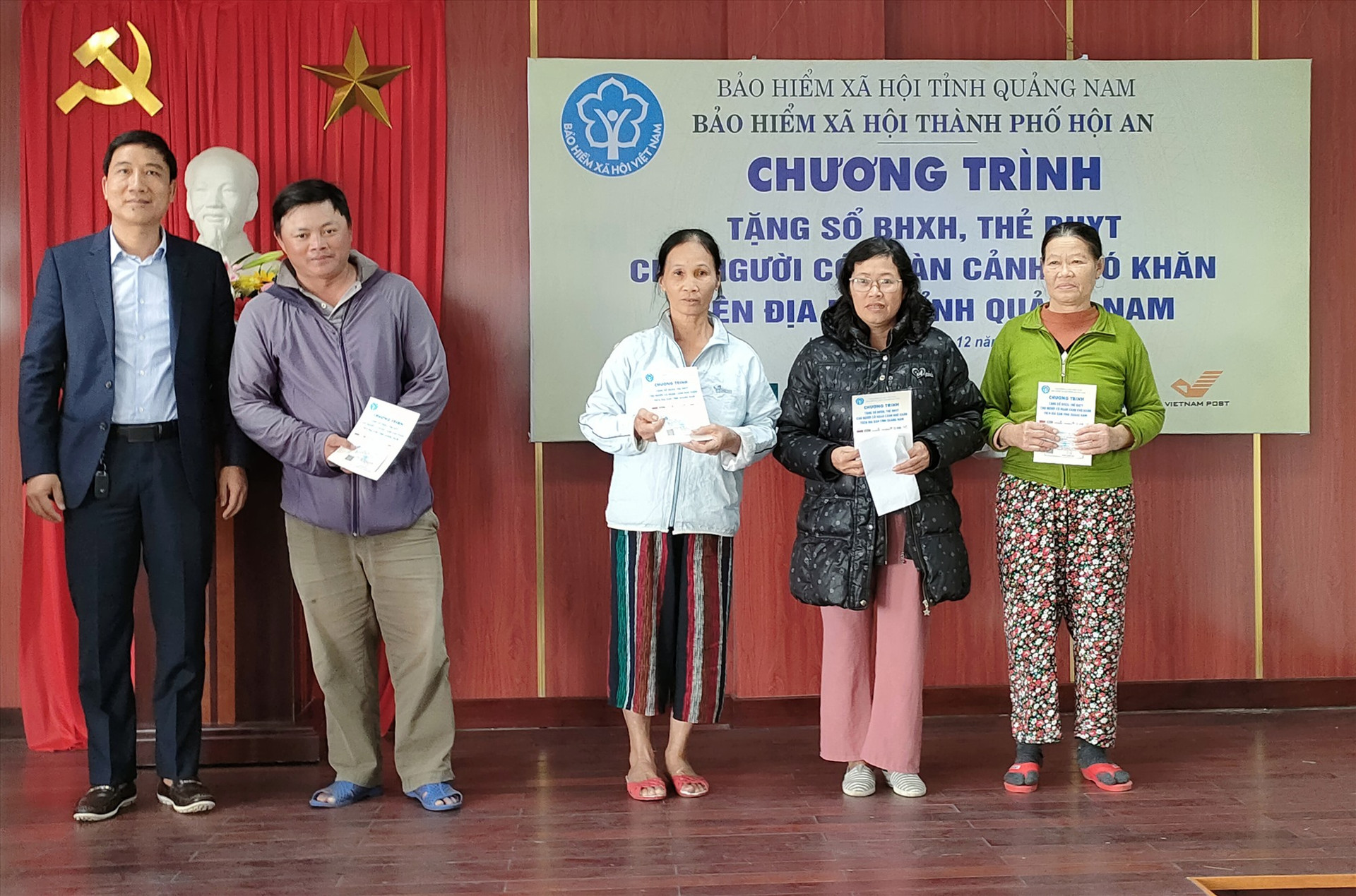 Đại diện Ngân hàng TMCP Ngoại thương Việt Nam - Chi nhánh Quảng Nam trao hỗ trợ 5 thẻ BHYT. Ảnh: MỸ LỆ