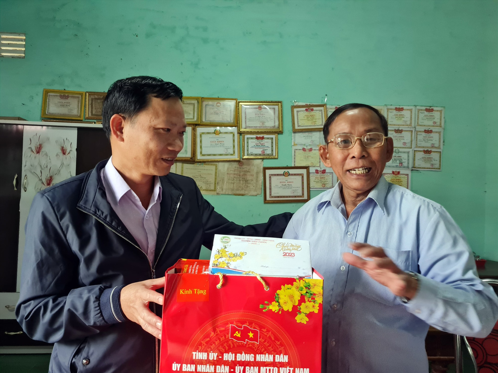 Phần quà của UBND tỉnh và các khoản trợ cấp tết đã được Bí thư Đảng ủy xã Tiên Phong Nguyễn Văn Ty trao đến tay thương binh Nguyễn Thoàng. ẢNH: D.L