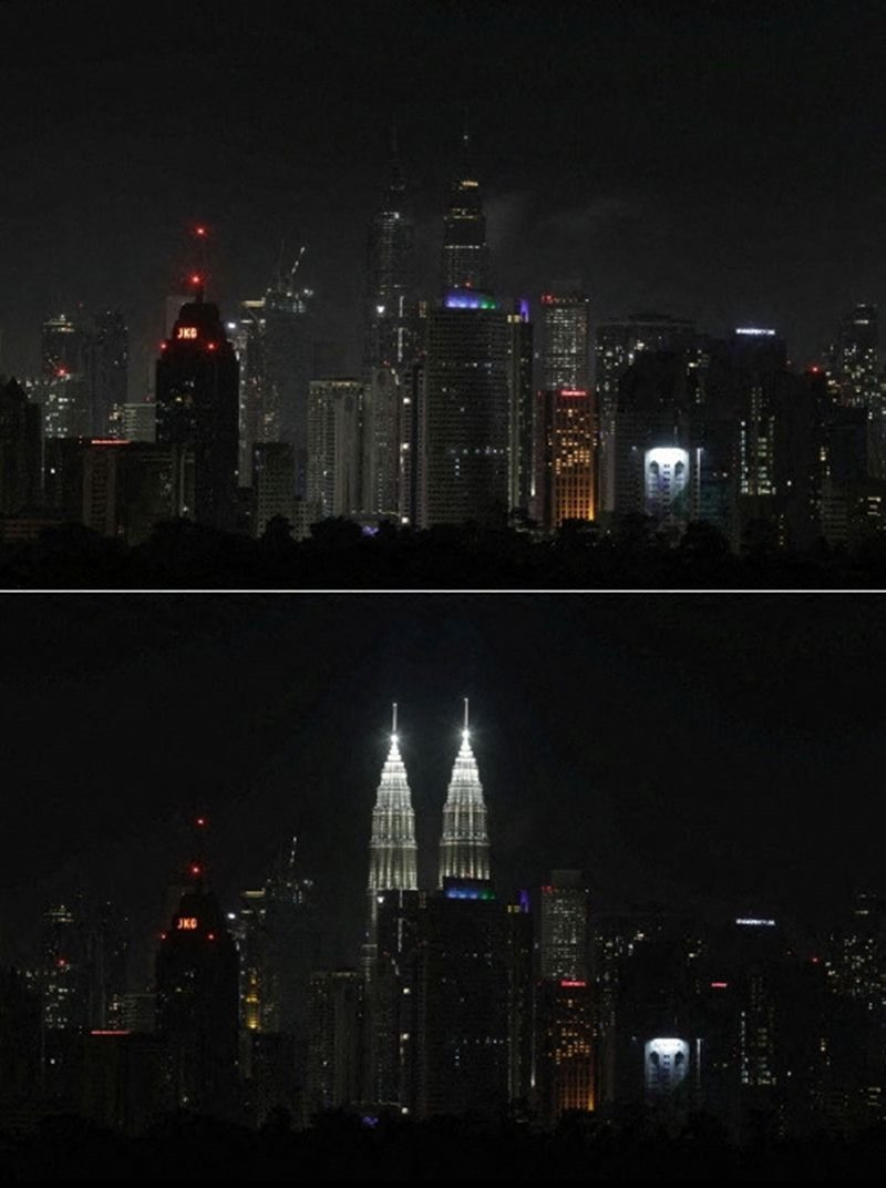 Đường chân trời của Kuala Lumpur với Tháp đôi Petronas ở trung tâm, trong và sau khi quan sát Giờ Trái đất, ở Kuala Lumpur, Malaysia.