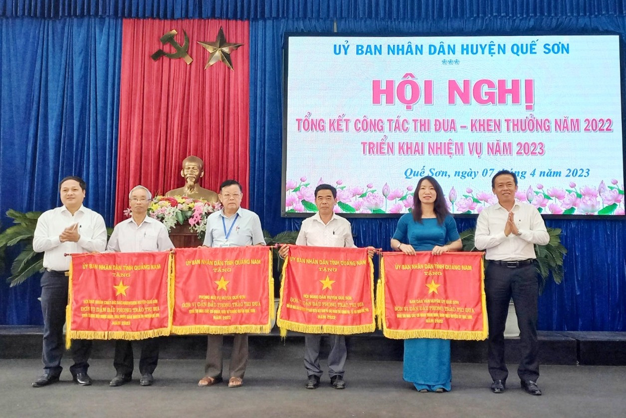 Lãnh đạo huyện Quế Sơn trao Cờ thi đua của UBND tỉnh cho 4 tập thể. Ảnh: Duy Thái