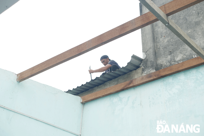 Hộ gia đình ông Huỳnh Văn Quang (tổ 36, phường Hòa Quý) đang tháo dỡ nhà ở, di dời đồ đạc để bàn giao mặt bằng phục vụ thi công dự án Khu đô thị ven sông Hòa Quý - Đồng Nò. Ảnh: HOÀNG HIỆP