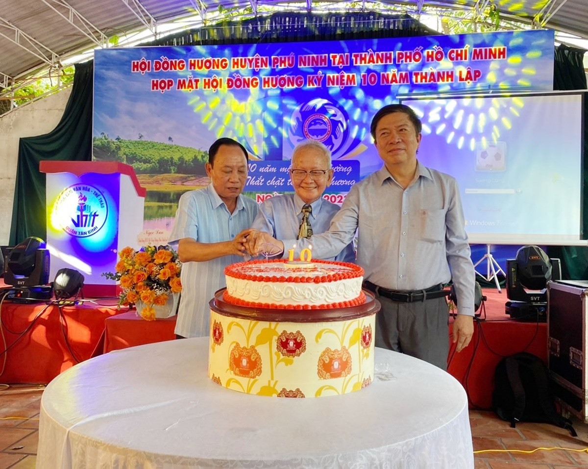 Ông Vũ Văn Thẩm - Bí thư Huyện ủy Phú Ninh (bên trái) cùng đại diện Ban Liên lạc Hội đồng hương Phú Ninh tại TP.Hồ Chí Minh thực hiện nghi thức cắt bánh sinh nhật kỷ niệm 10 năm thành lập hội. Ảnh: P.V
