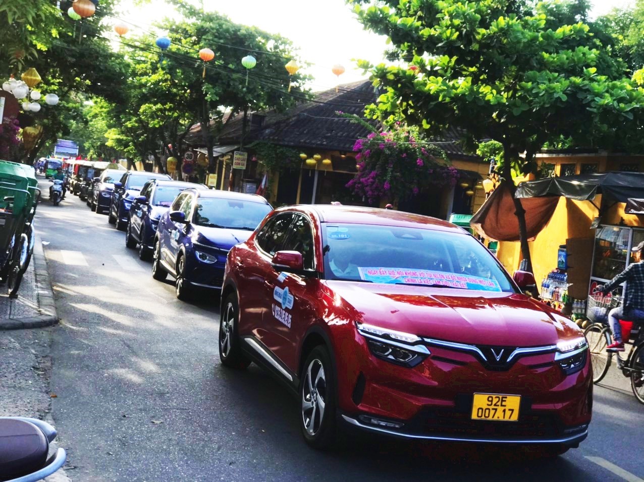 Electric cars in a parade with the message of environmental protection