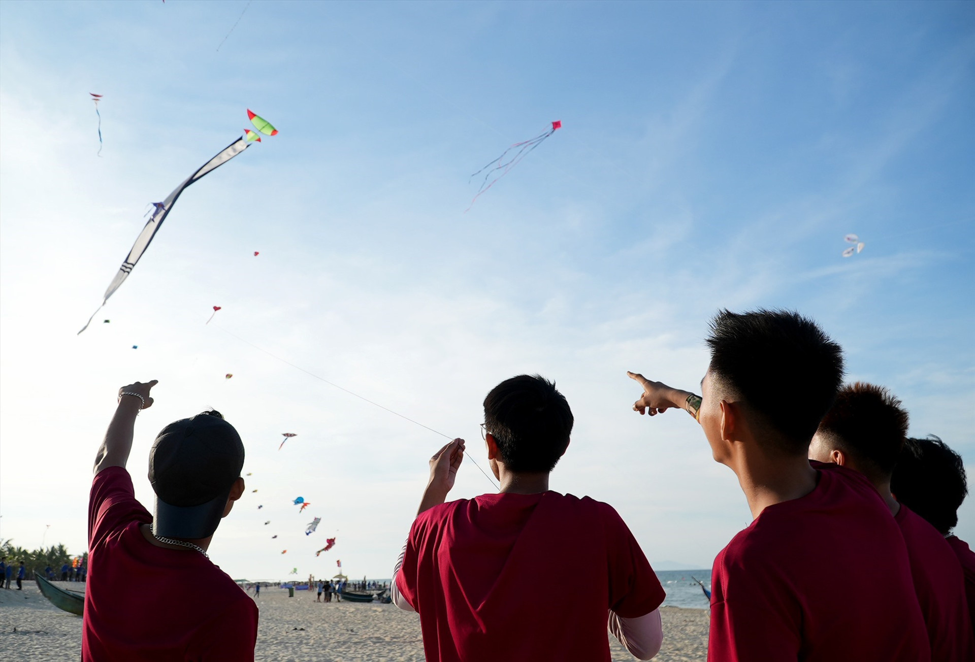 Competitors controlling the kites flying the sky