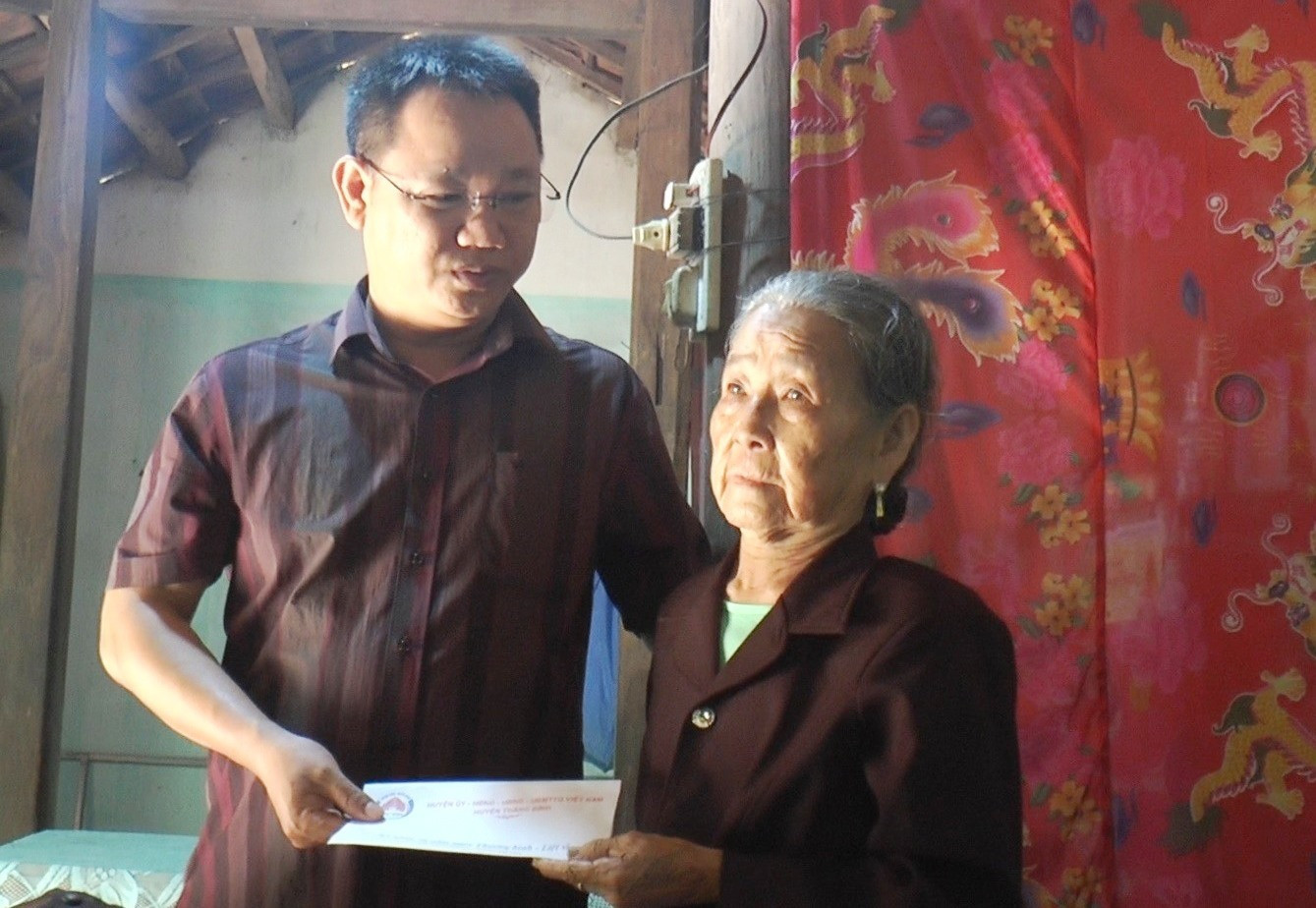Ông Trương Công Sơn, Phó Chủ tịch UBND huyện tặng quà cho gia đình NCC Nguyễn Thị Thê, xã Bình An. Ảnh: Đ.H